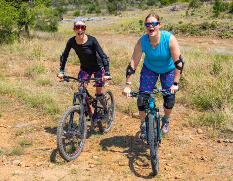 Two women Mountain biking in SHREDLY mountain bike clothing.
