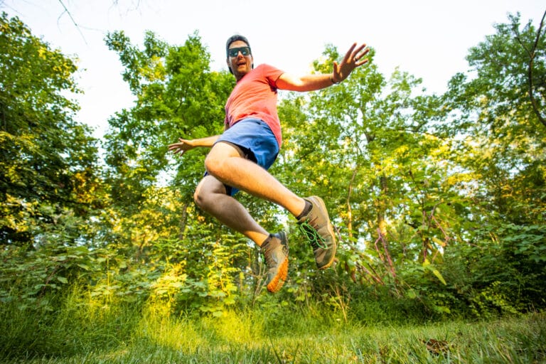 a man jumps for joy in barefoot shoes.