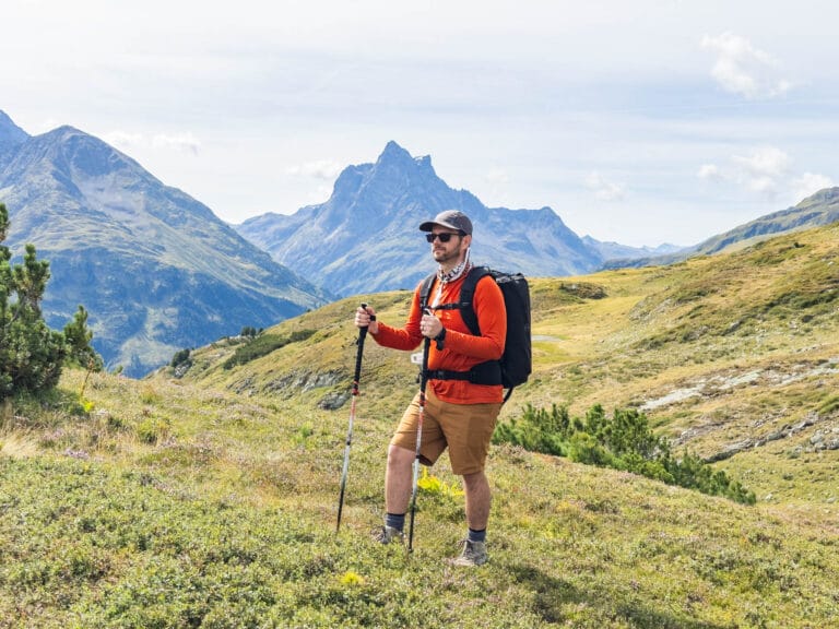 A man wears a sun shirt while hiking in the Austrian Alps.